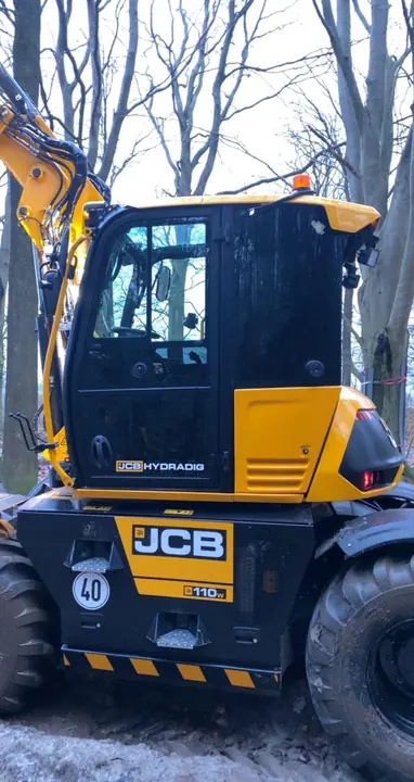 JCB-graafmachine voorzien van belettering